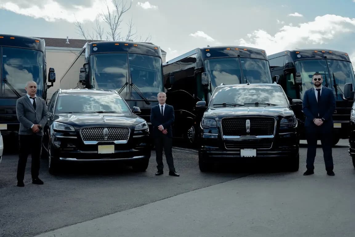 King & Queen Limo chauffeurs standing with Lincoln SUVs and coach buses
