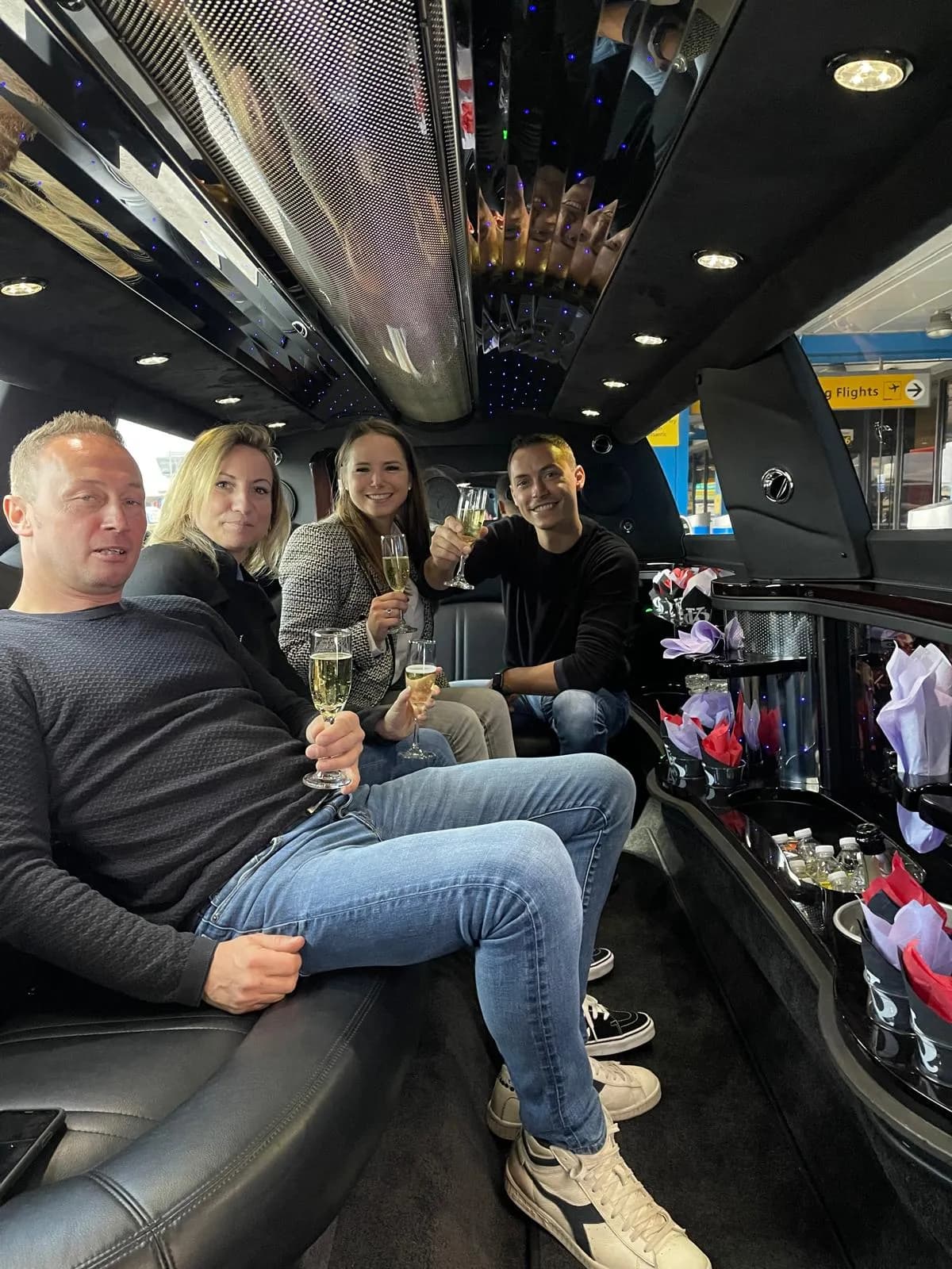 Group toasting inside a stretch limousine on the way to a casino night