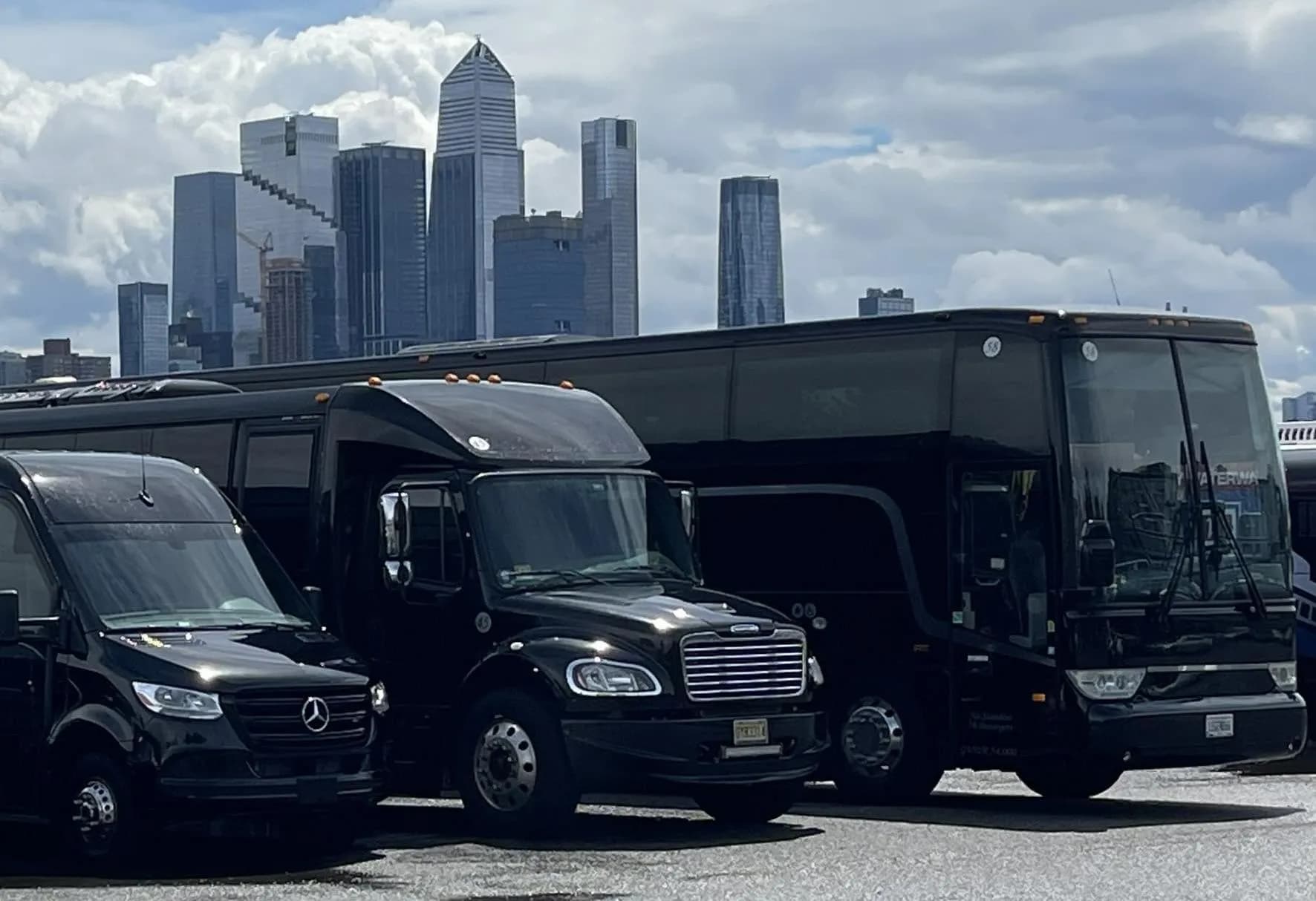 Sprinter van, shuttle bus and coach bus with the Hudson Yards skyline behind