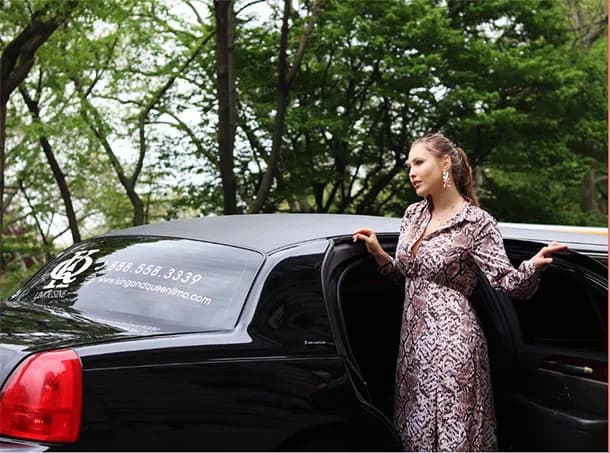 Guest stepping into a King & Queen branded black stretch limousine