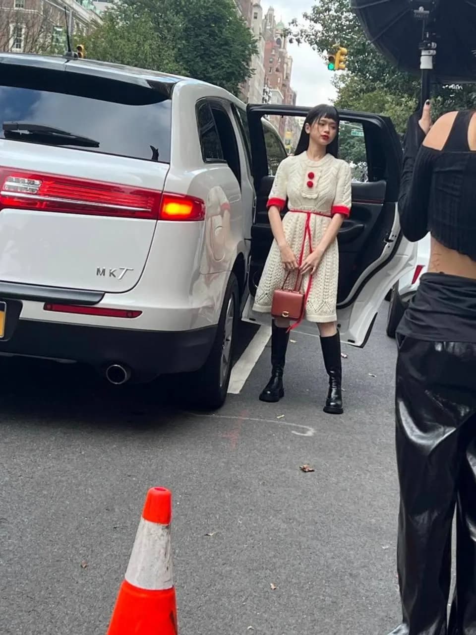Model stepping out of a white Lincoln MKT during a New York fashion shoot