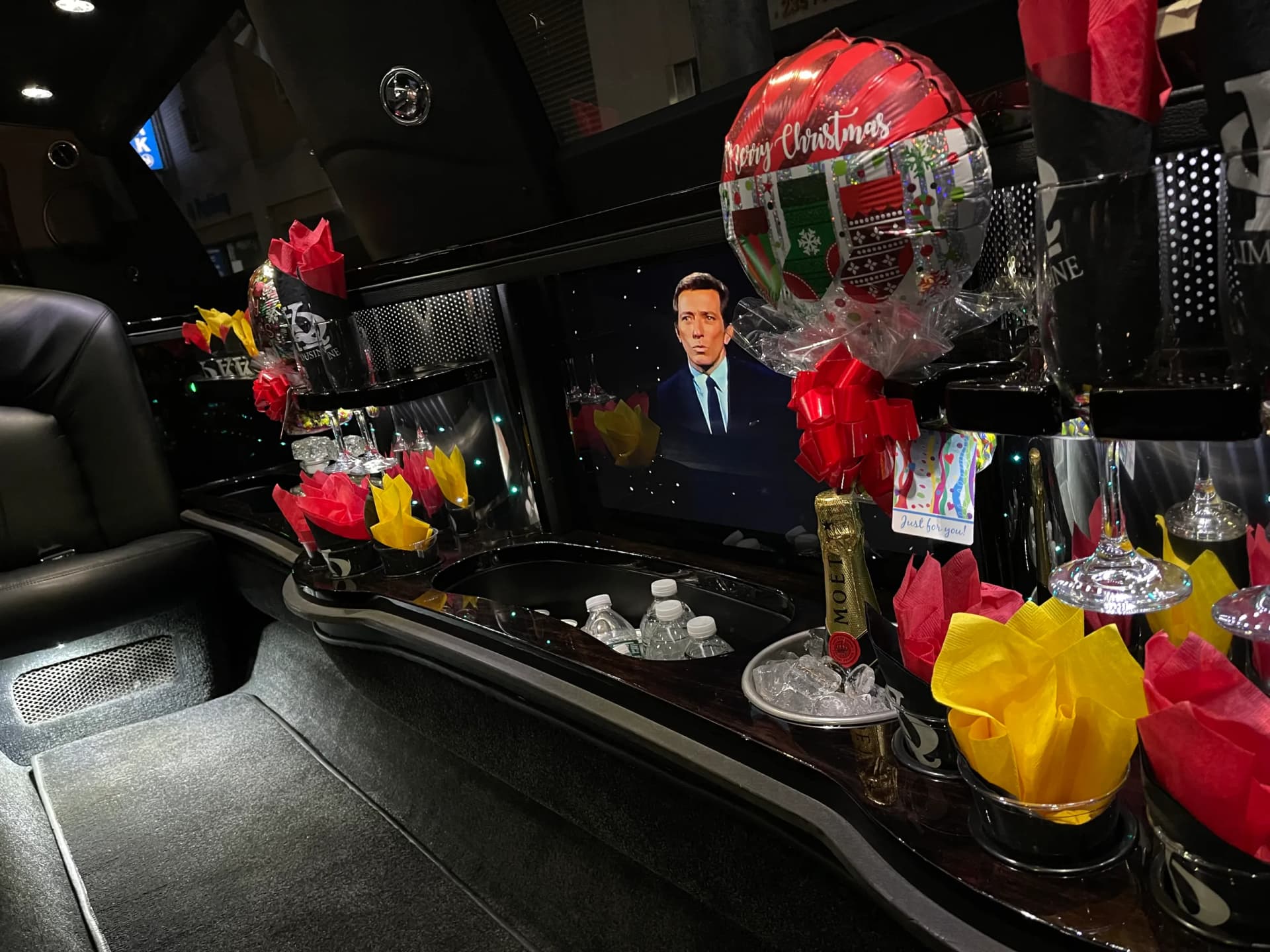 Limousine bar set for Christmas with a balloon, champagne and iced water
