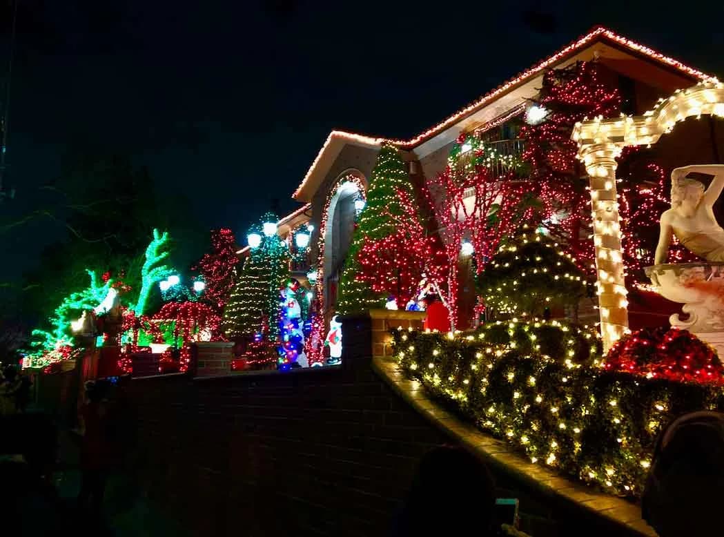 Fully decorated Dyker Heights house glowing on the Christmas lights tour