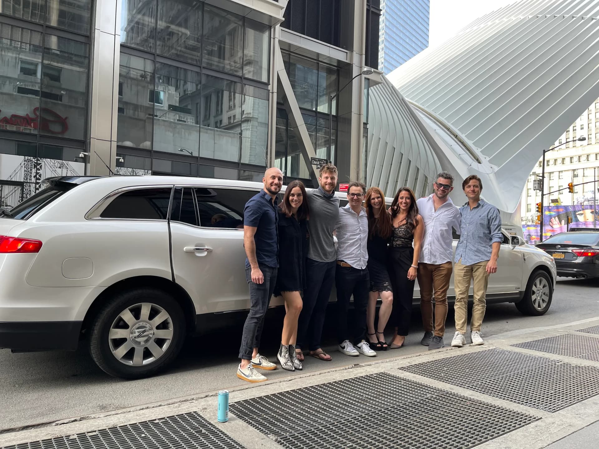 Group of friends with a white limousine outside the Oculus in Lower Manhattan