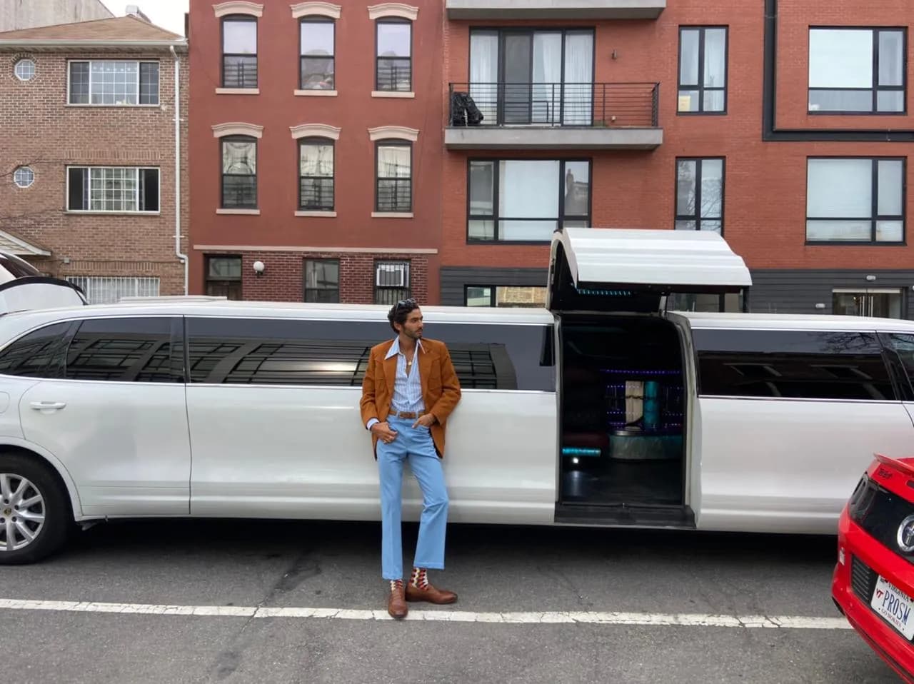 White stretch limousine with jet door open on a Brooklyn street