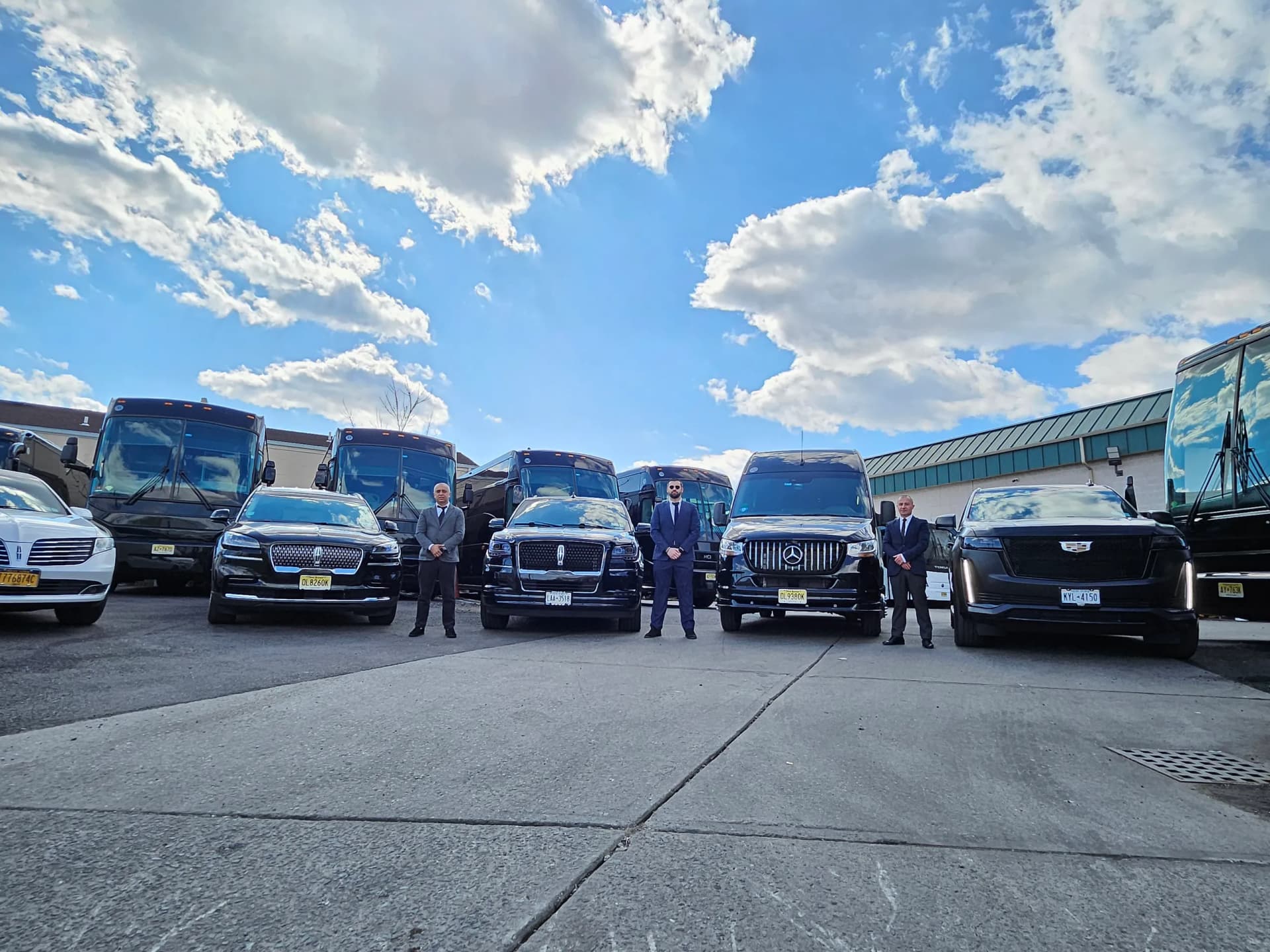 King & Queen Limo fleet of luxury SUVs, Mercedes Sprinter vans and motorcoaches lined up with professional chauffeurs in NYC.