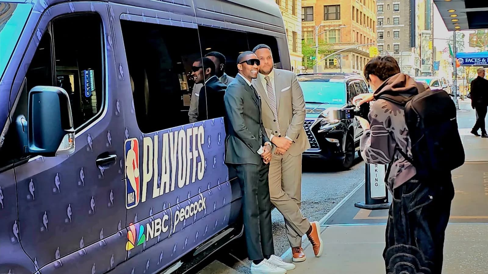 Guests in formal attire beside an NBA Playoffs Sprinter van during an event pickup in Manhattan.