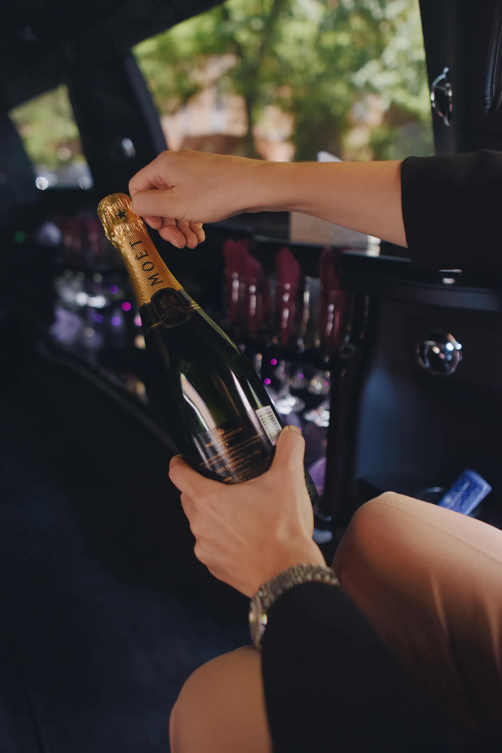 Opening a chilled bottle of champagne on the limousine ride