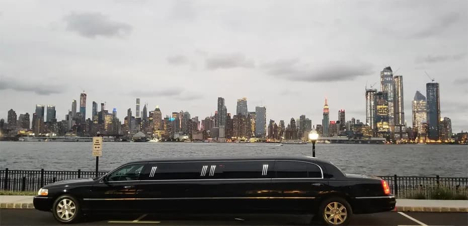Black Lincoln stretch limousine with the Manhattan skyline across the river