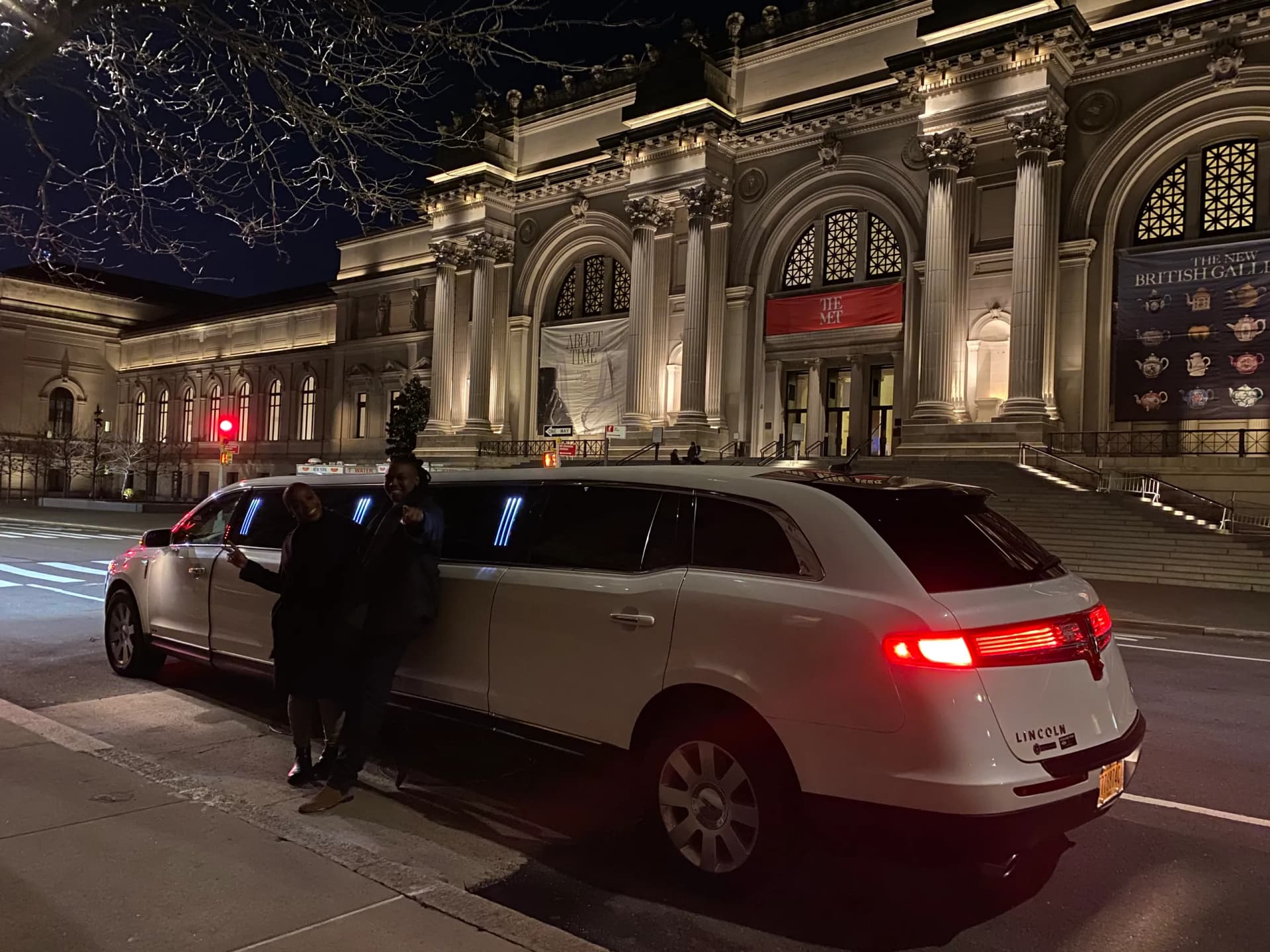 White Lincoln limousine outside the Metropolitan Museum of Art at night