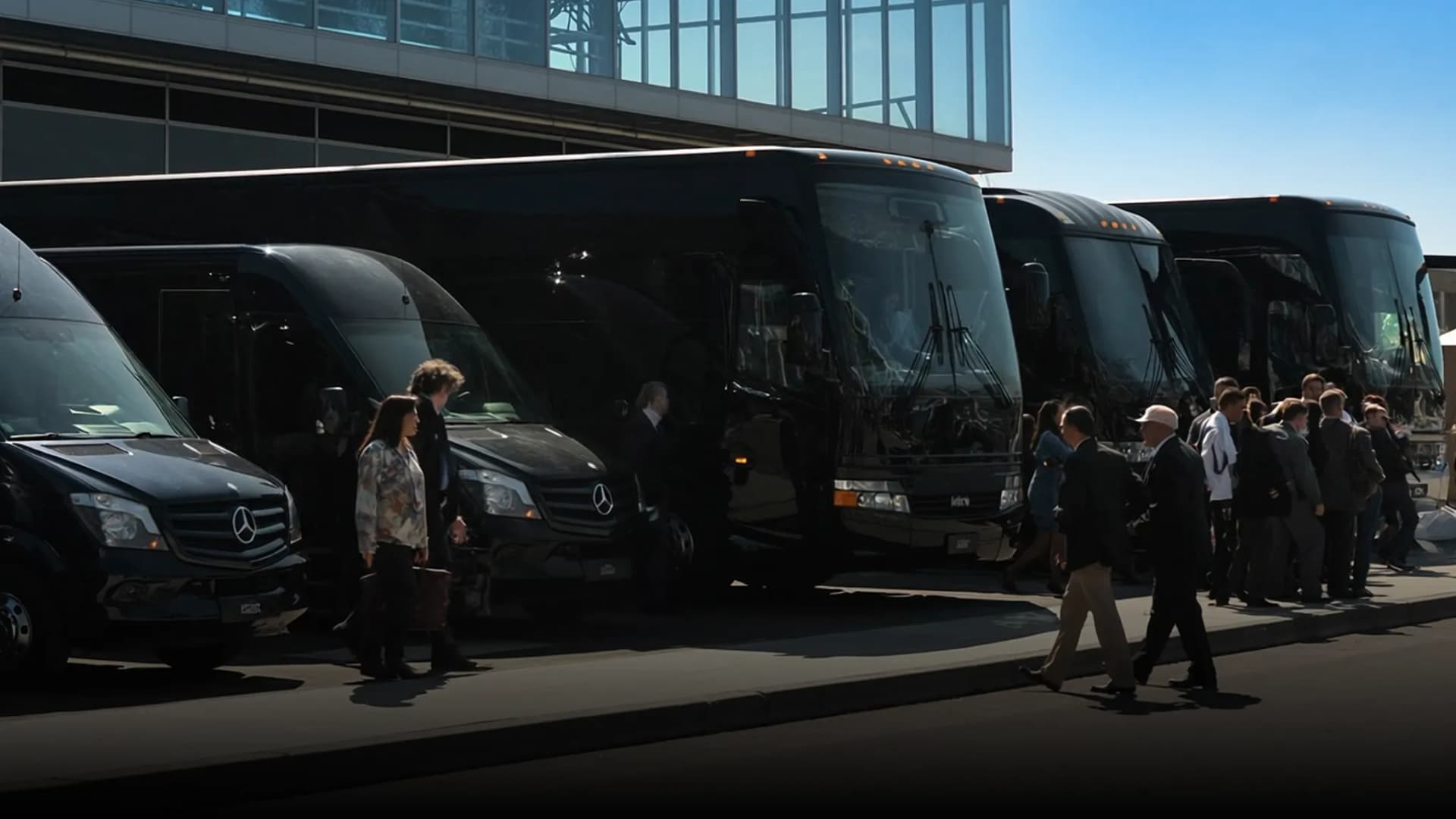 Business travelers boarding Sprinter vans and coach buses