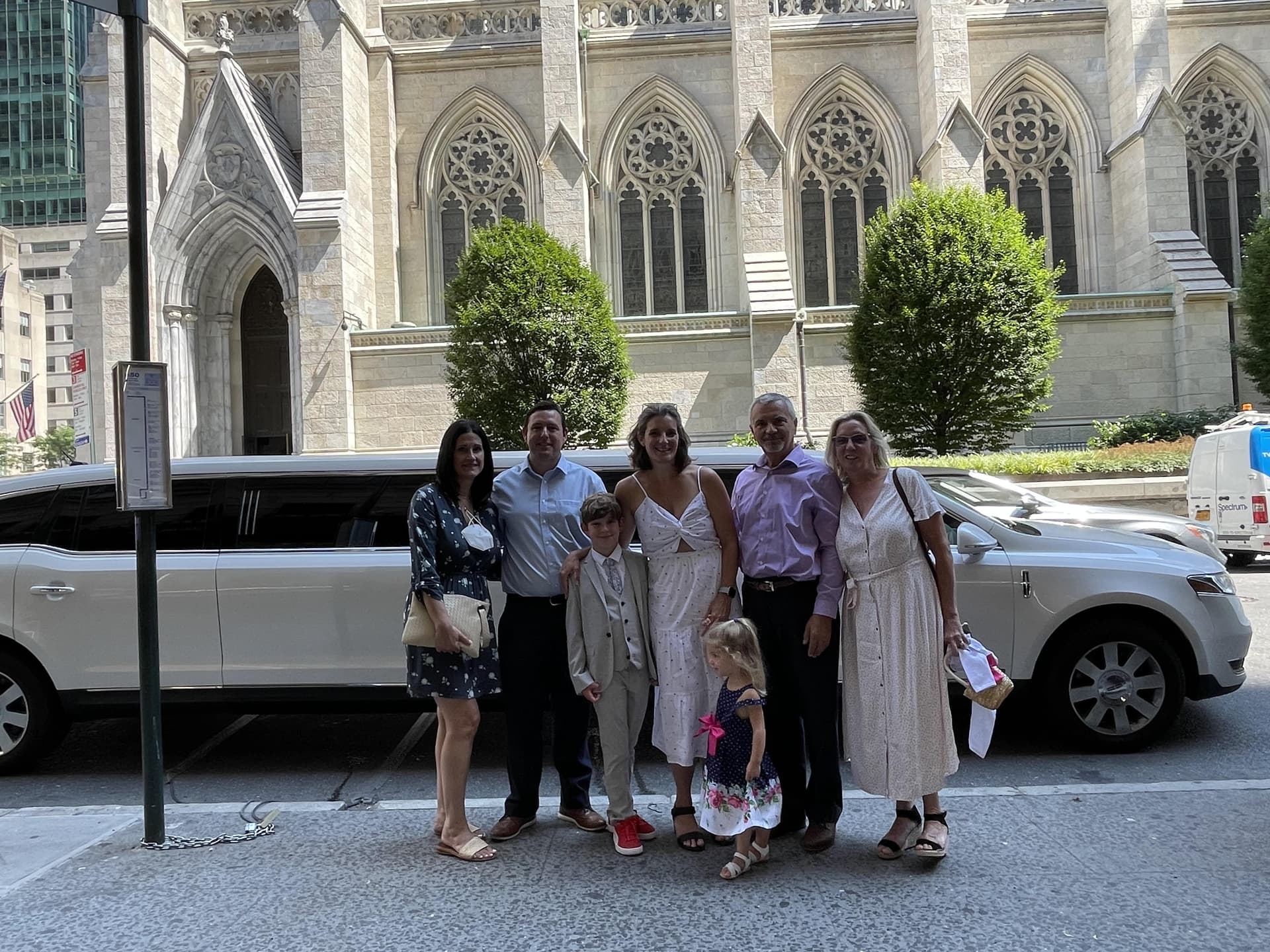 Family with a white Lincoln stretch limousine outside St. Patrick's Cathedral