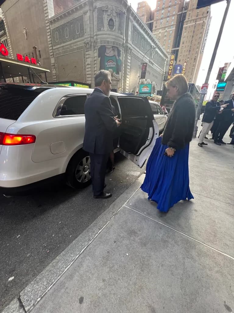 Chauffeur holding the limousine door for a guest near Times Square