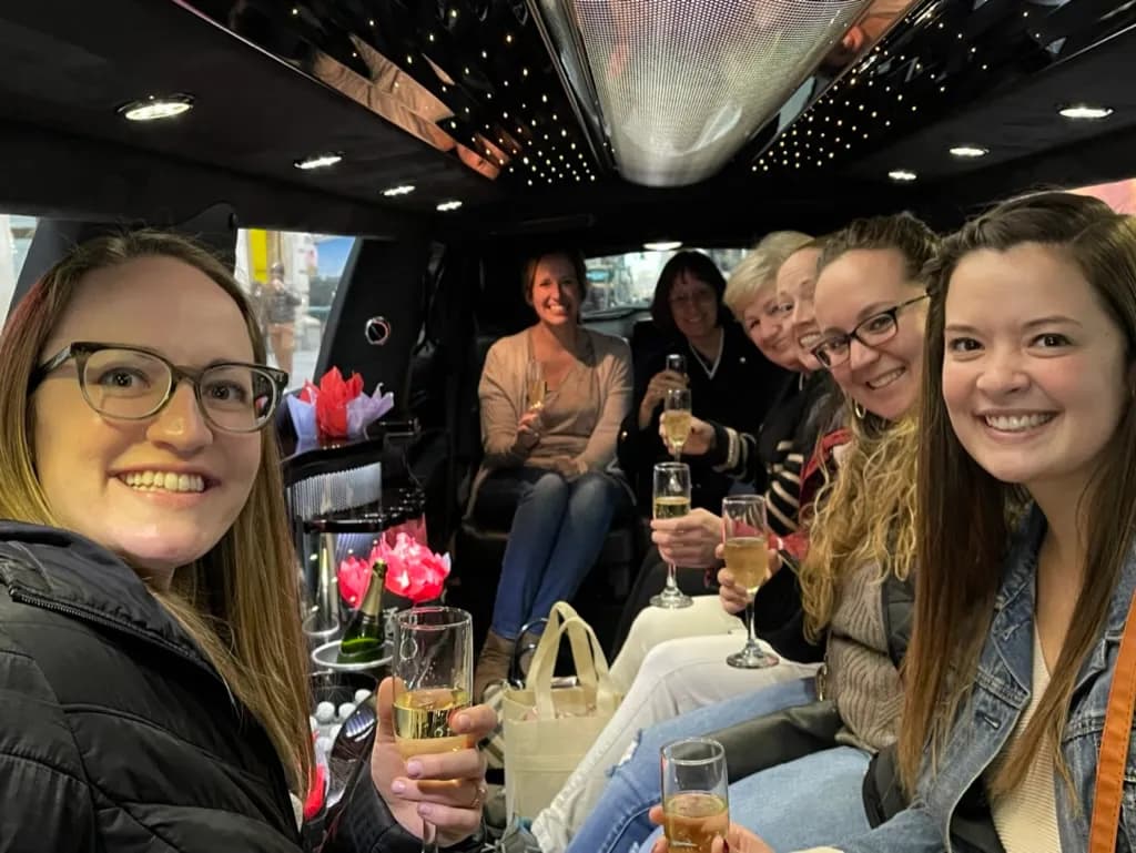 Friends toasting with champagne inside a stretch limousine