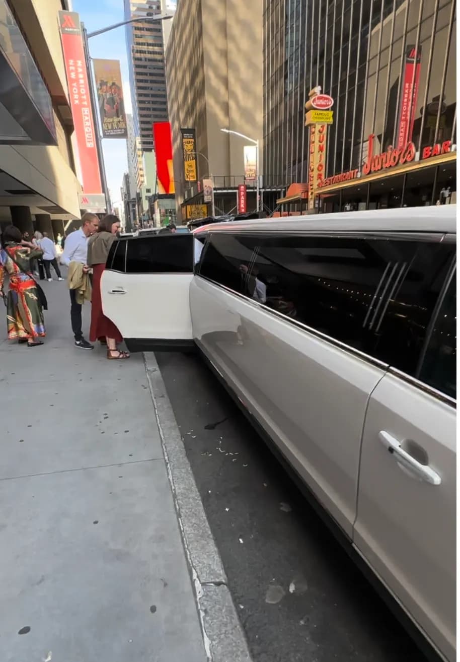 Guests boarding a white stretch limousine in the Theater District