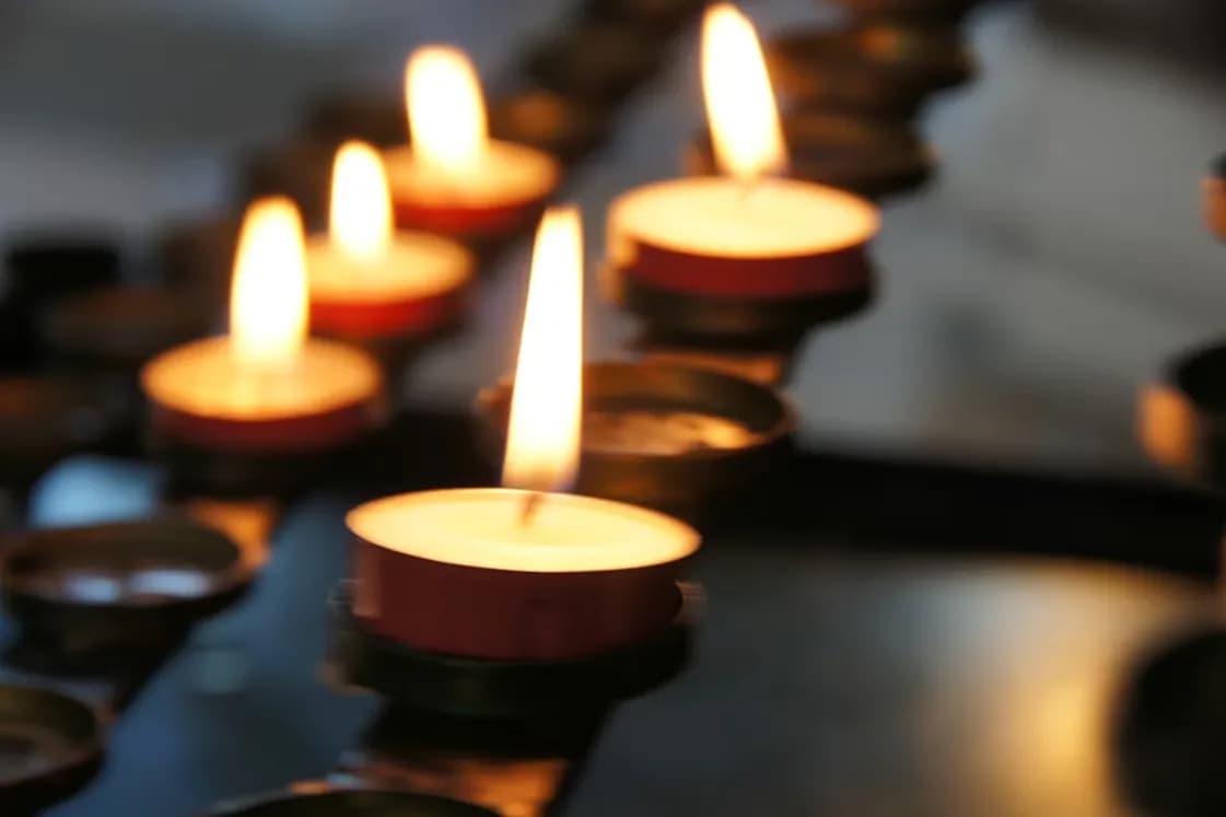 Memorial candles glowing in soft light