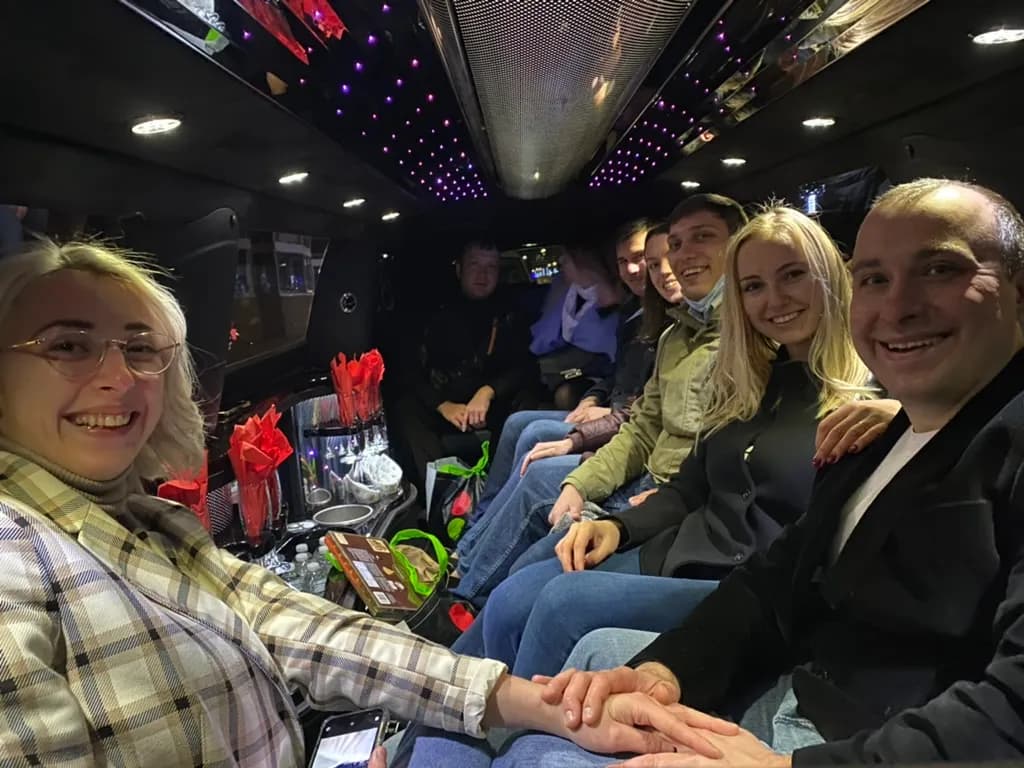 Group on a night out inside a stretch limousine with a starlight ceiling