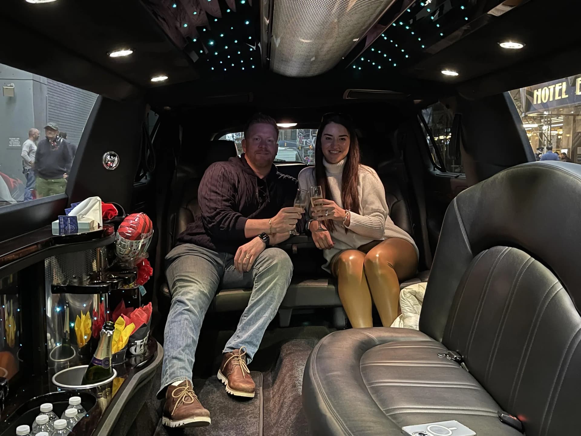 Couple toasting inside a stretch limousine on an evening ride