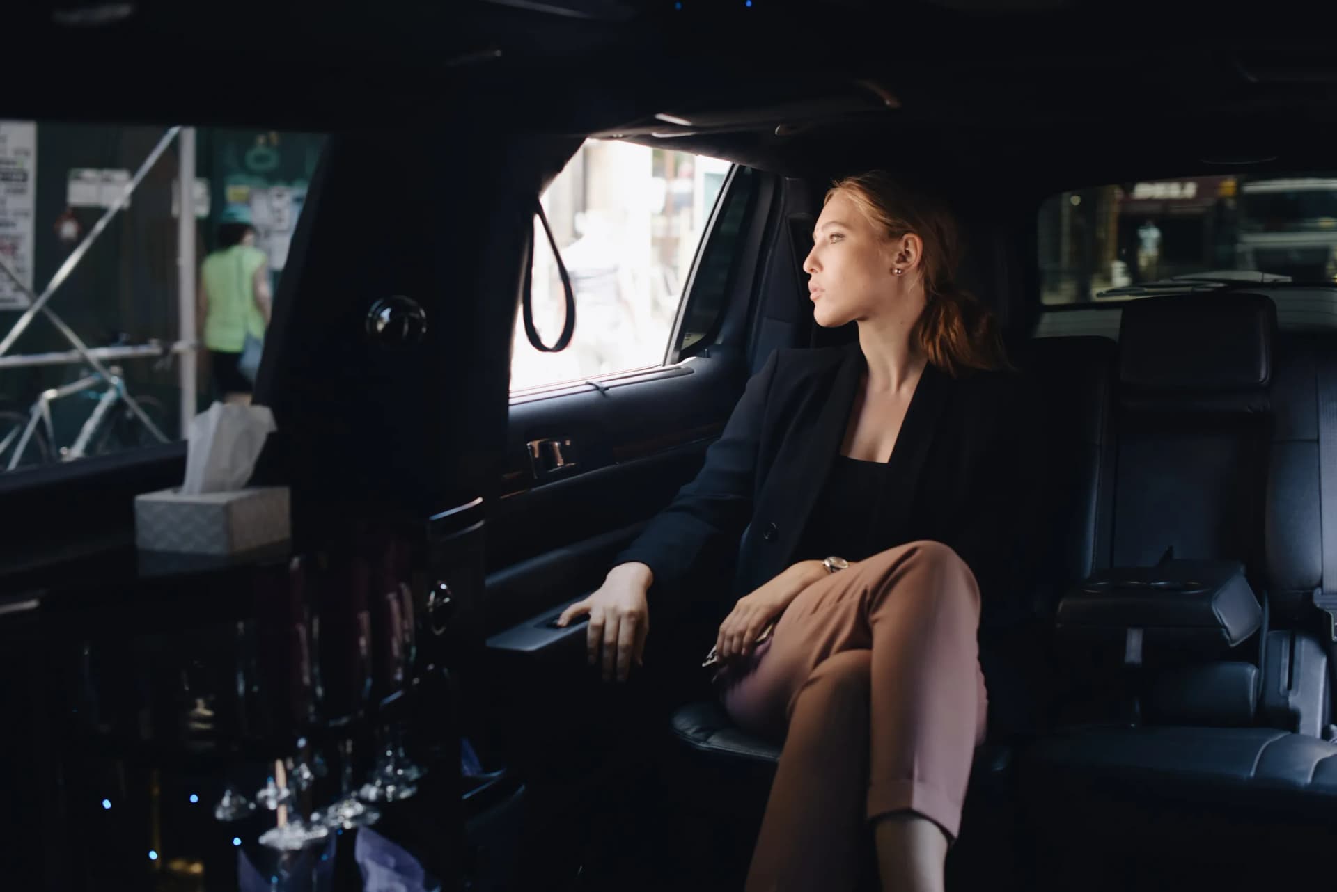 Passenger looking out the limousine window on a point to point trip
