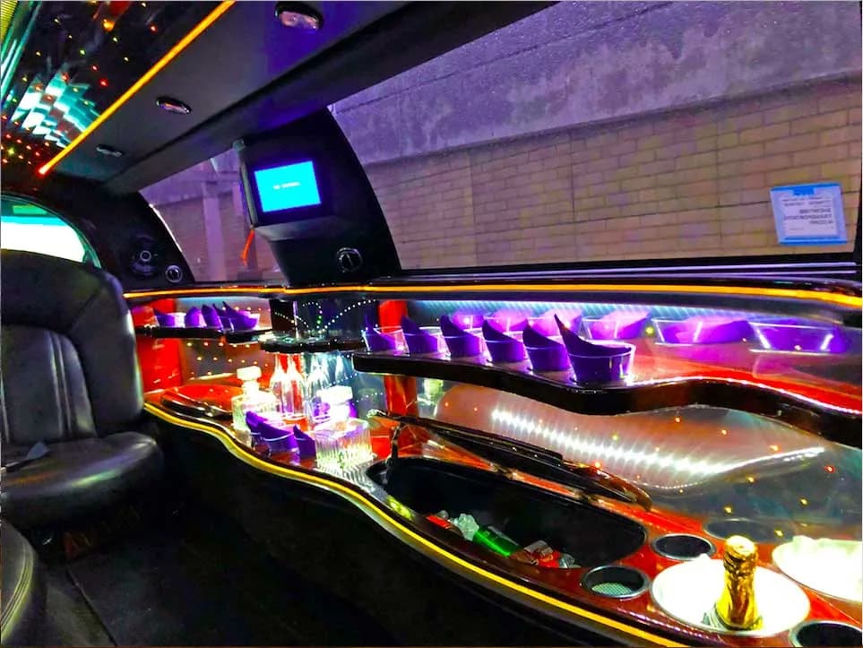 Stretch limousine interior with lighted bar, glasses and champagne on ice