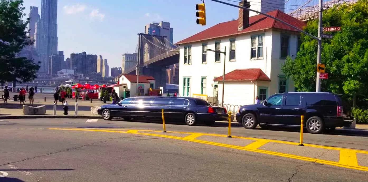 Stretch limousine and black SUV near the Brooklyn Bridge at Old Fulton Street