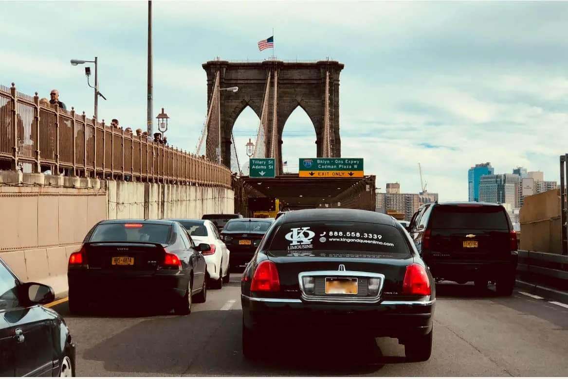 King & Queen branded Lincoln limousine crossing the Brooklyn Bridge