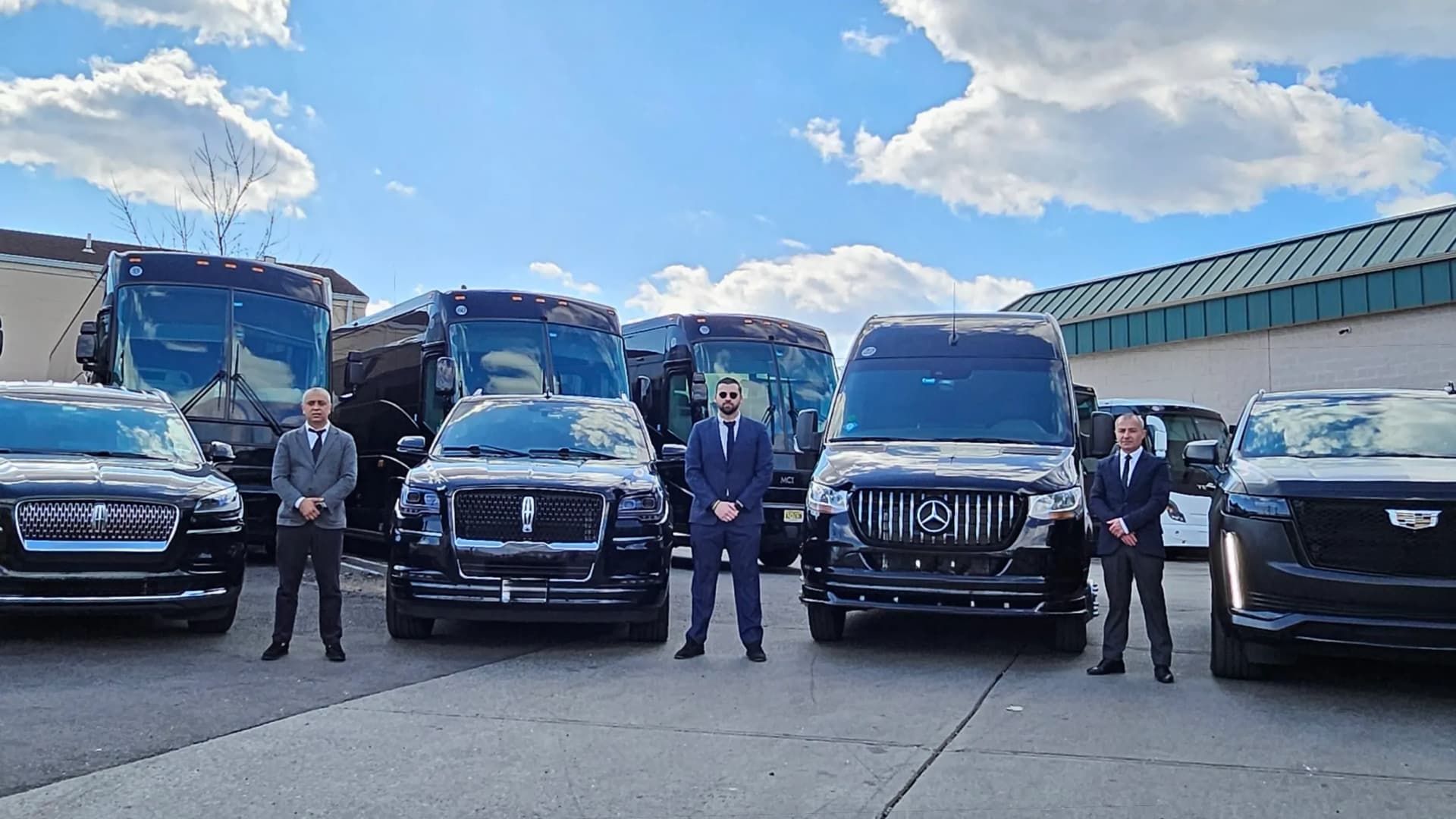 Three chauffeurs standing with the Navigator, Sprinter and Escalade fleet
