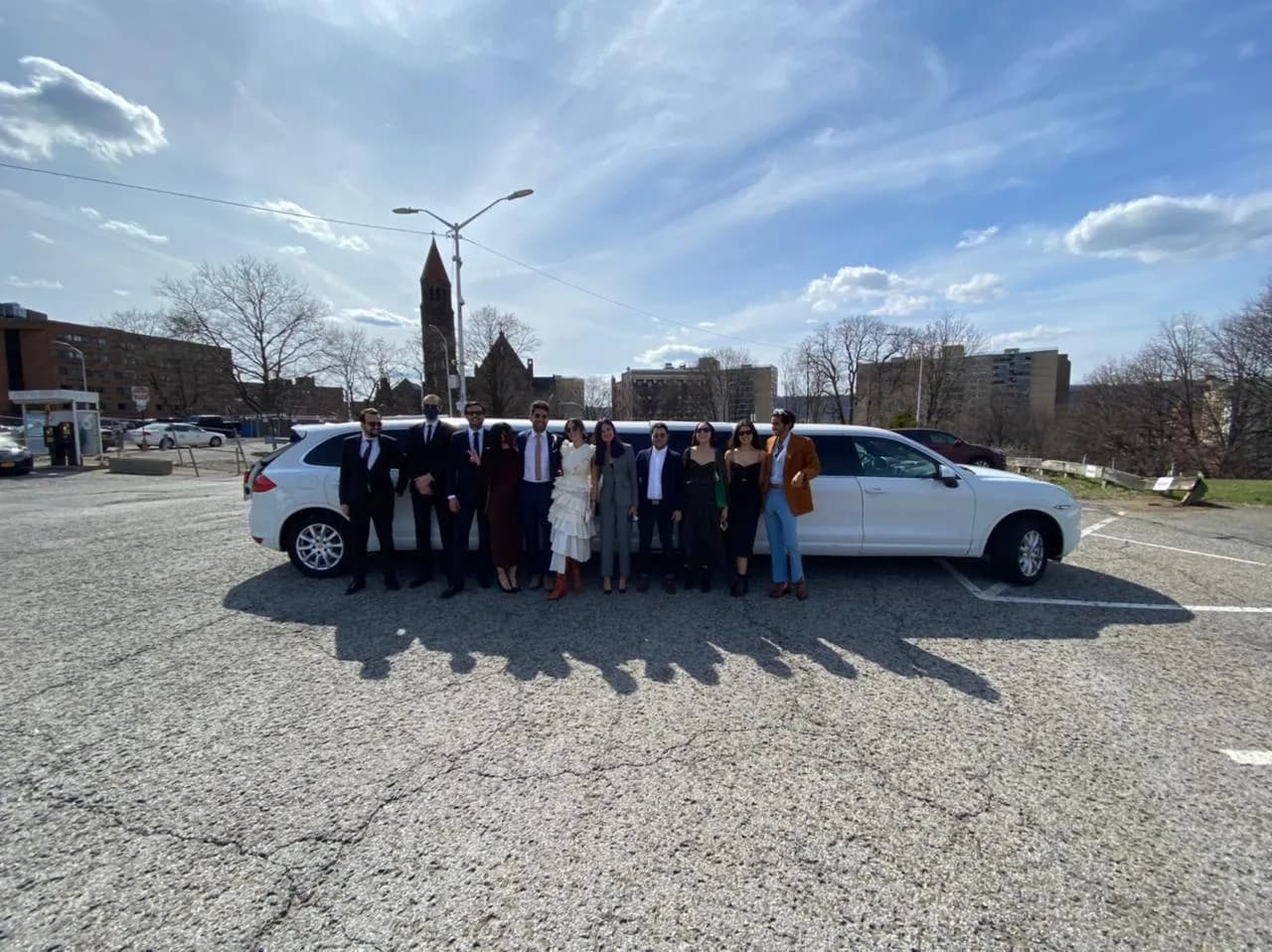Family beside a black stretch limousine before a day trip
