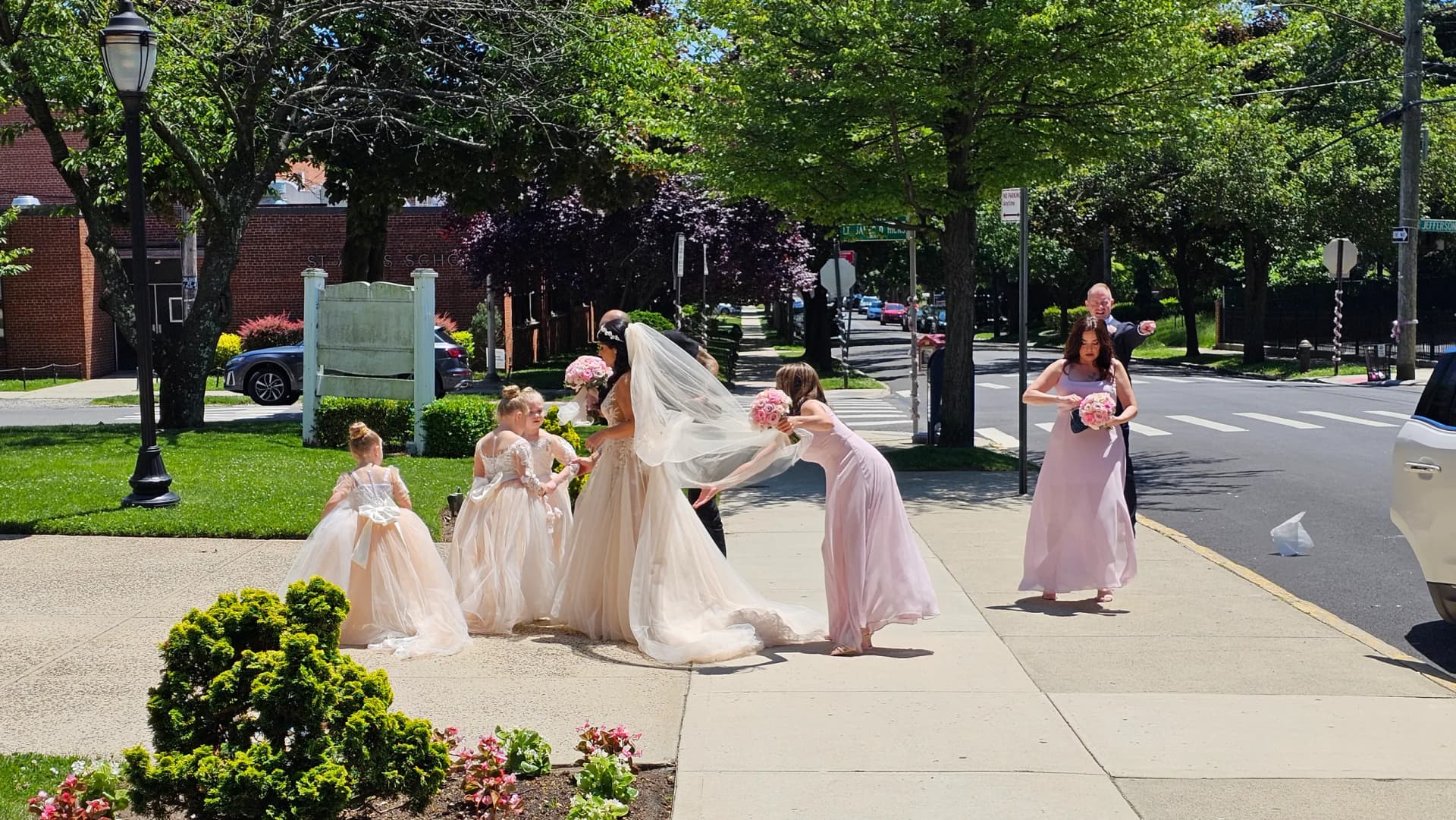 Flower girls and bridesmaids in blush dresses arriving at the church