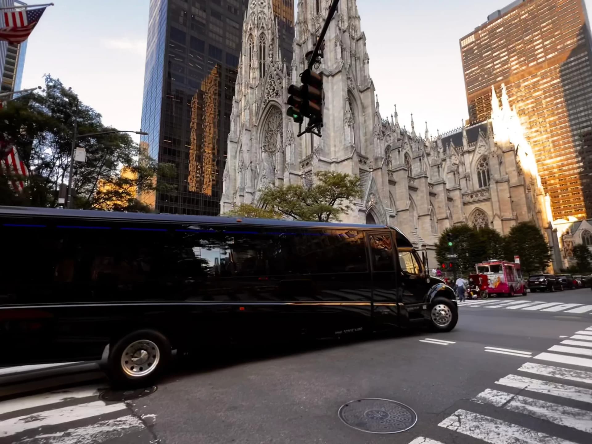Black mini coach bus passing St. Patrick's Cathedral on Fifth Avenue