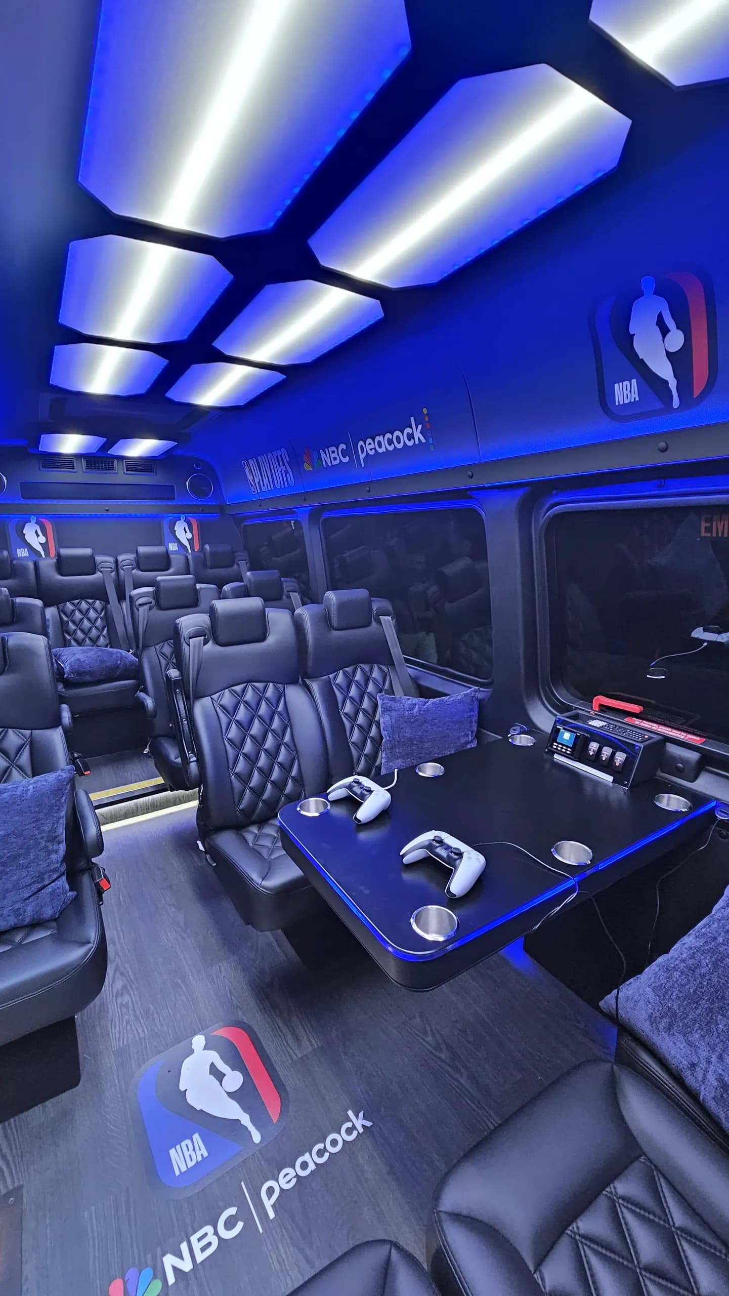 NBA and Peacock branded Sprinter interior with gaming consoles and leather seats