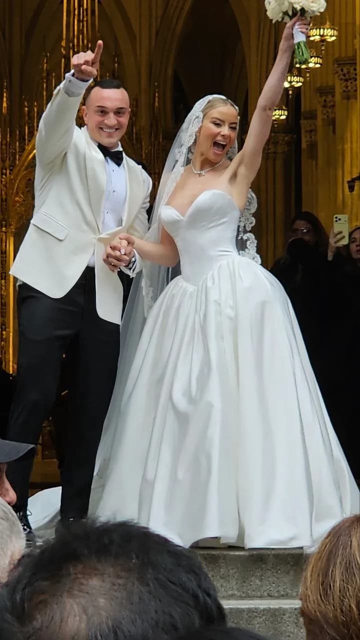 Newlyweds cheer on the steps of St. Patrick's Cathedral