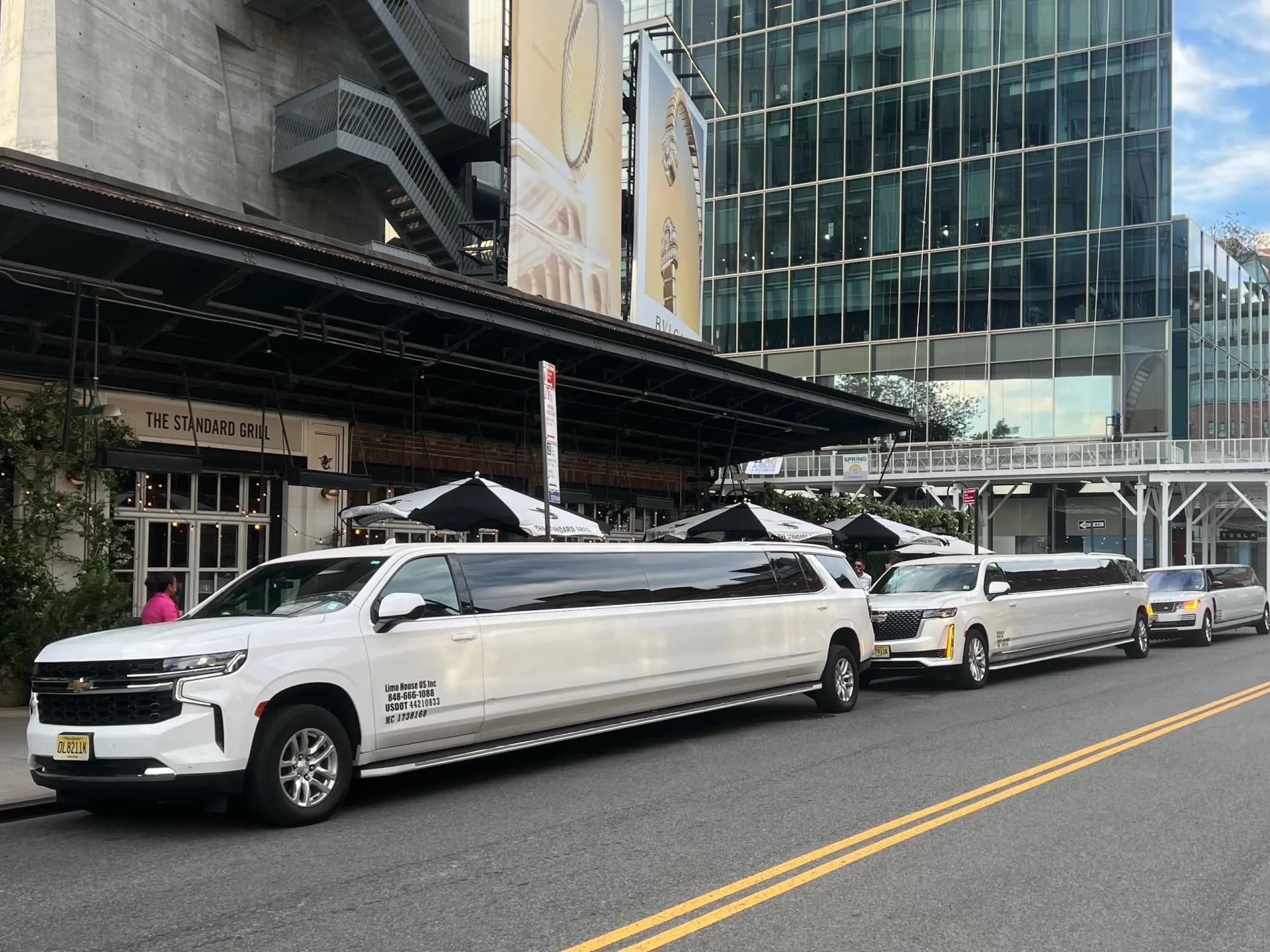 White Suburban stretch limousines lined up outside the Standard Grill